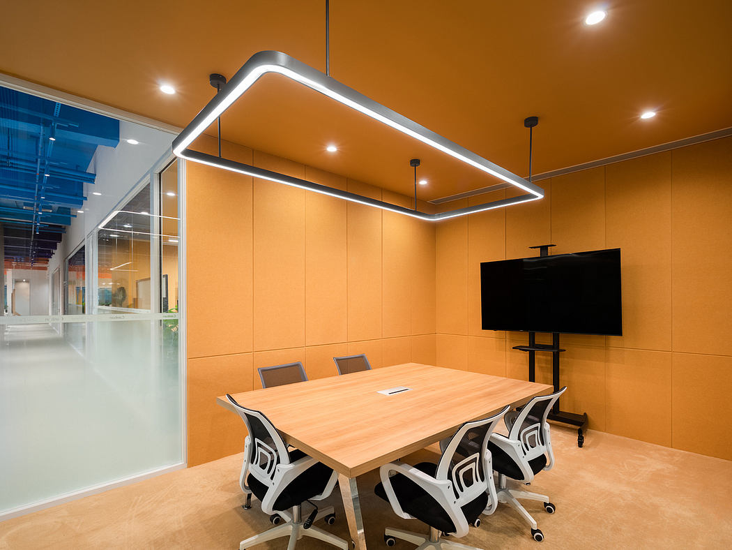 Modern meeting room with sleek lighting fixture, wooden table, and swivel chairs on a beige-toned backdrop.