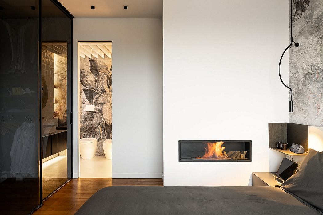 Minimalist bedroom with modern fireplace, abstract wall art, and glass-paneled doorway.
