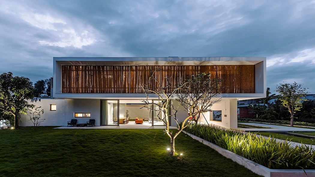 Striking modern architecture with wooden facade, landscaped grounds, and illuminated details.