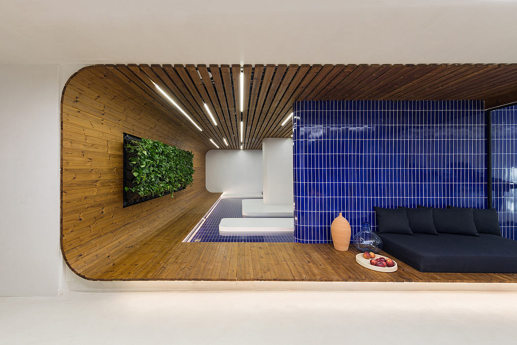 A modern, minimalist interior design featuring wooden slats, a living wall, and vibrant blue tiles.