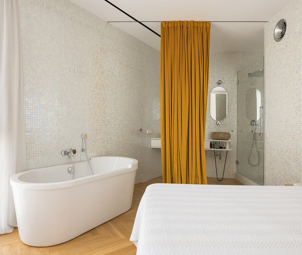 Spacious bathroom with a white tub, yellow curtain, and mosaic tile walls.
