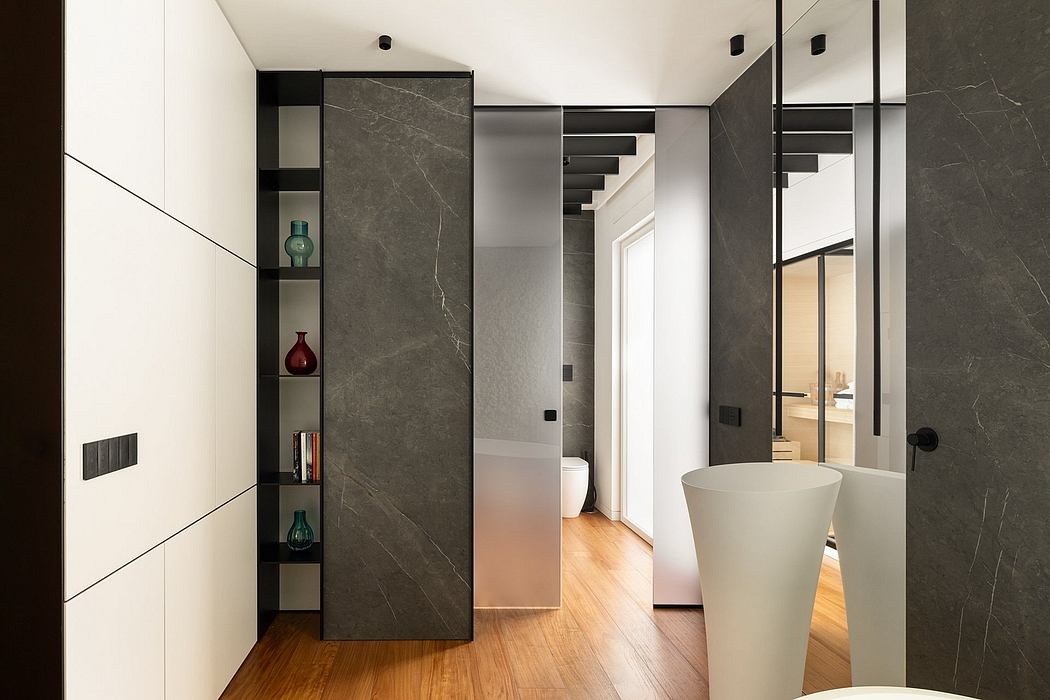 Striking modern interior design with sleek marble panels, shelving, and freestanding vanity.