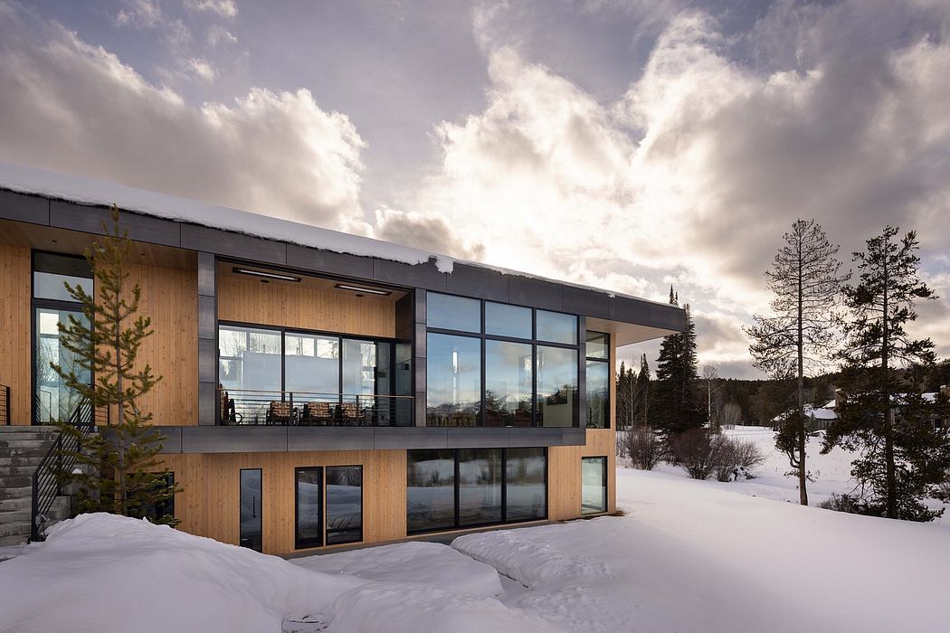 Sleek, modern architecture with wood and glass elements against a snowy landscape.
