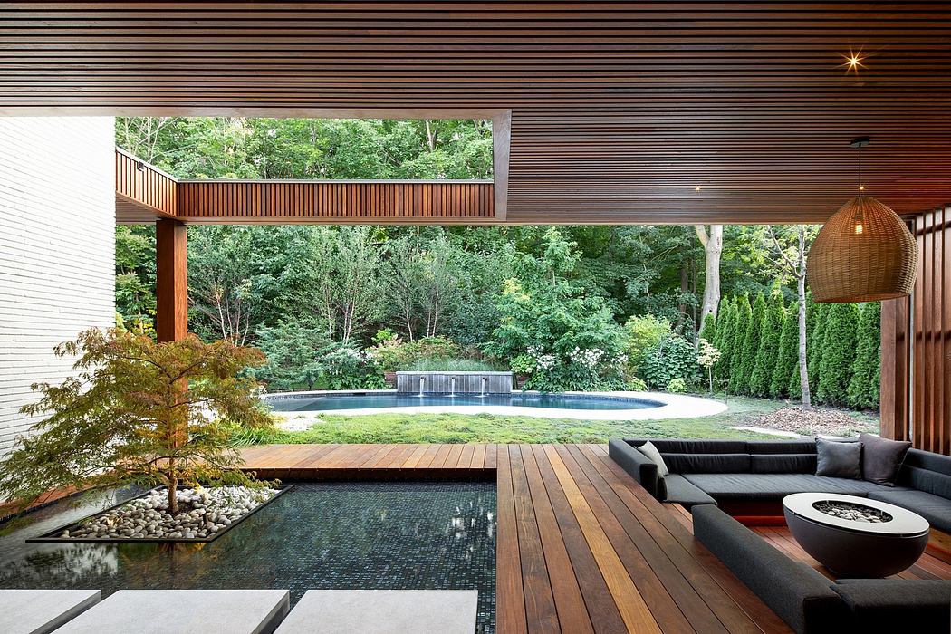 Stunning modern outdoor living space with infinity pool, lush greenery, and cozy seating.
