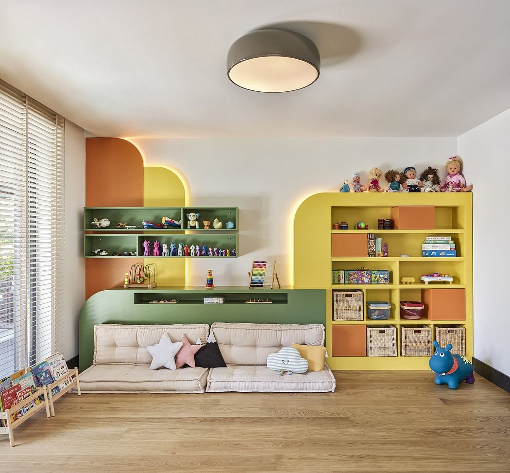 A cozy child's playroom with colorful built-in shelves, a comfy couch, and plush toys.