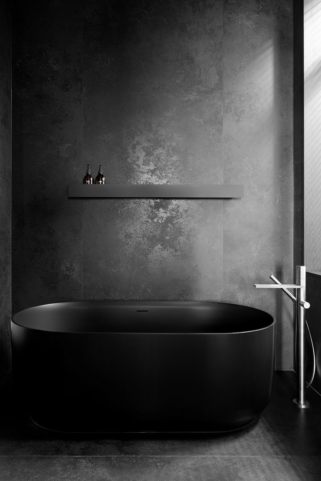 A minimalist bathroom design featuring a dark, oval-shaped bathtub and shelving with bottles against a moody concrete wall.