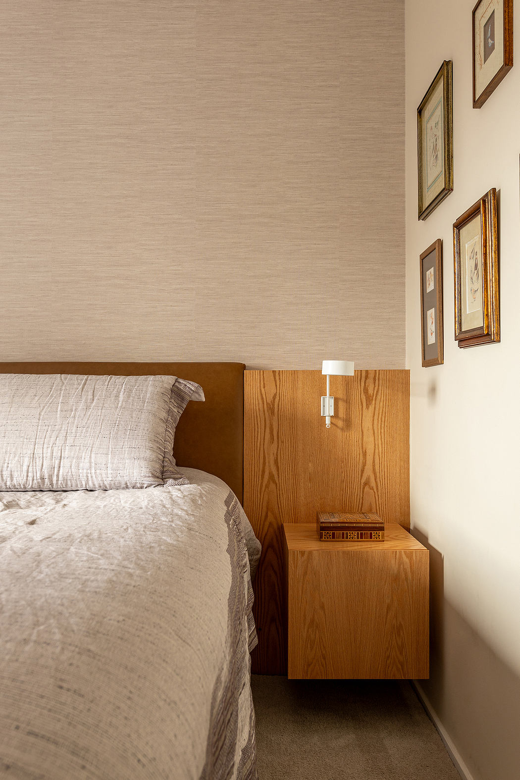 A cozy bedroom with warm wood tones, textured fabrics, and minimal decor highlighting the room's design.