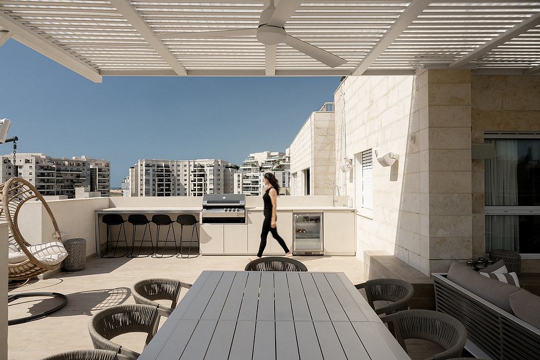 Outdoor patio with sleek, modern design elements including a covered seating area and built-in kitchen.