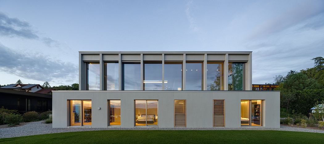 Contemporary two-story house with large windows, clean lines, and minimalist design.
