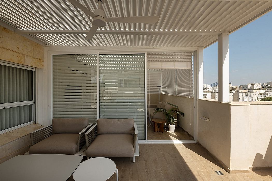 A modern covered balcony with minimalist furniture and floor-to-ceiling windows.