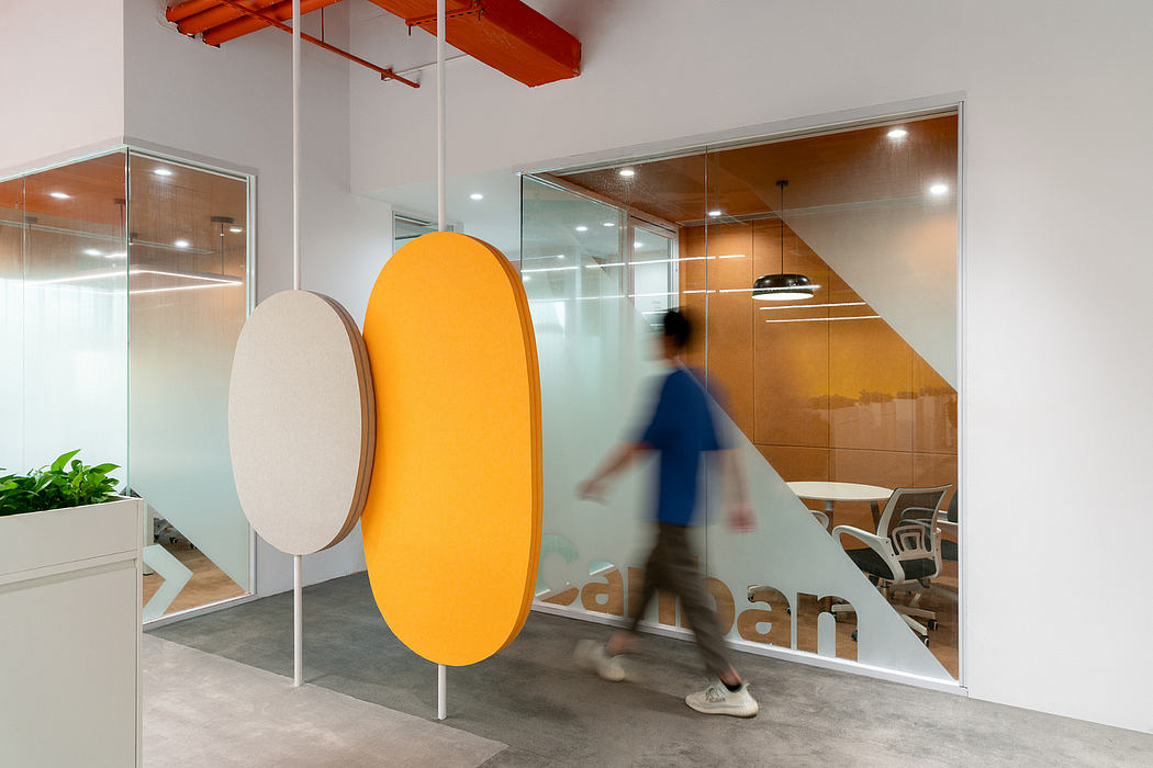 Sleek, modern office space with geometric glass panels and vibrant orange accents.