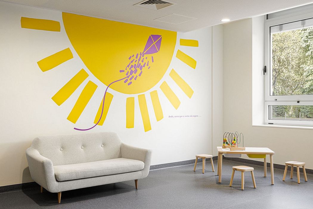 A modern, bright office space with a large, colorful sun mural on the wall and minimalist furniture.