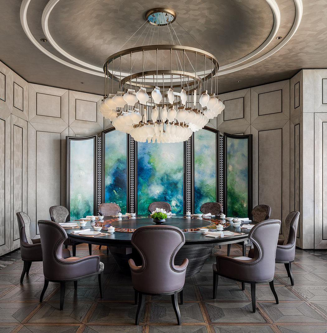 Ornate dining room with circular chandelier, patterned wall panels, and vibrant artwork.