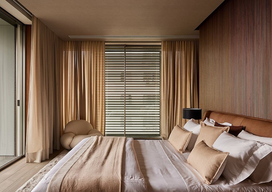 Luxurious bedroom showcasing modern architecture, warm tones, and sleek curtain design.