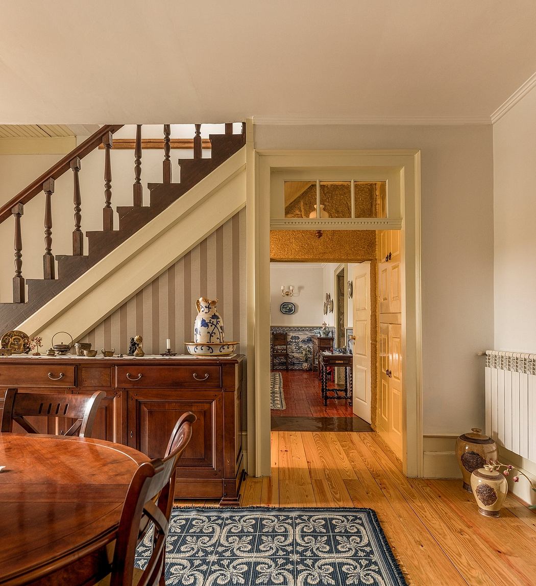 Cozy interior with wooden staircase, antique furniture, and decorative items.