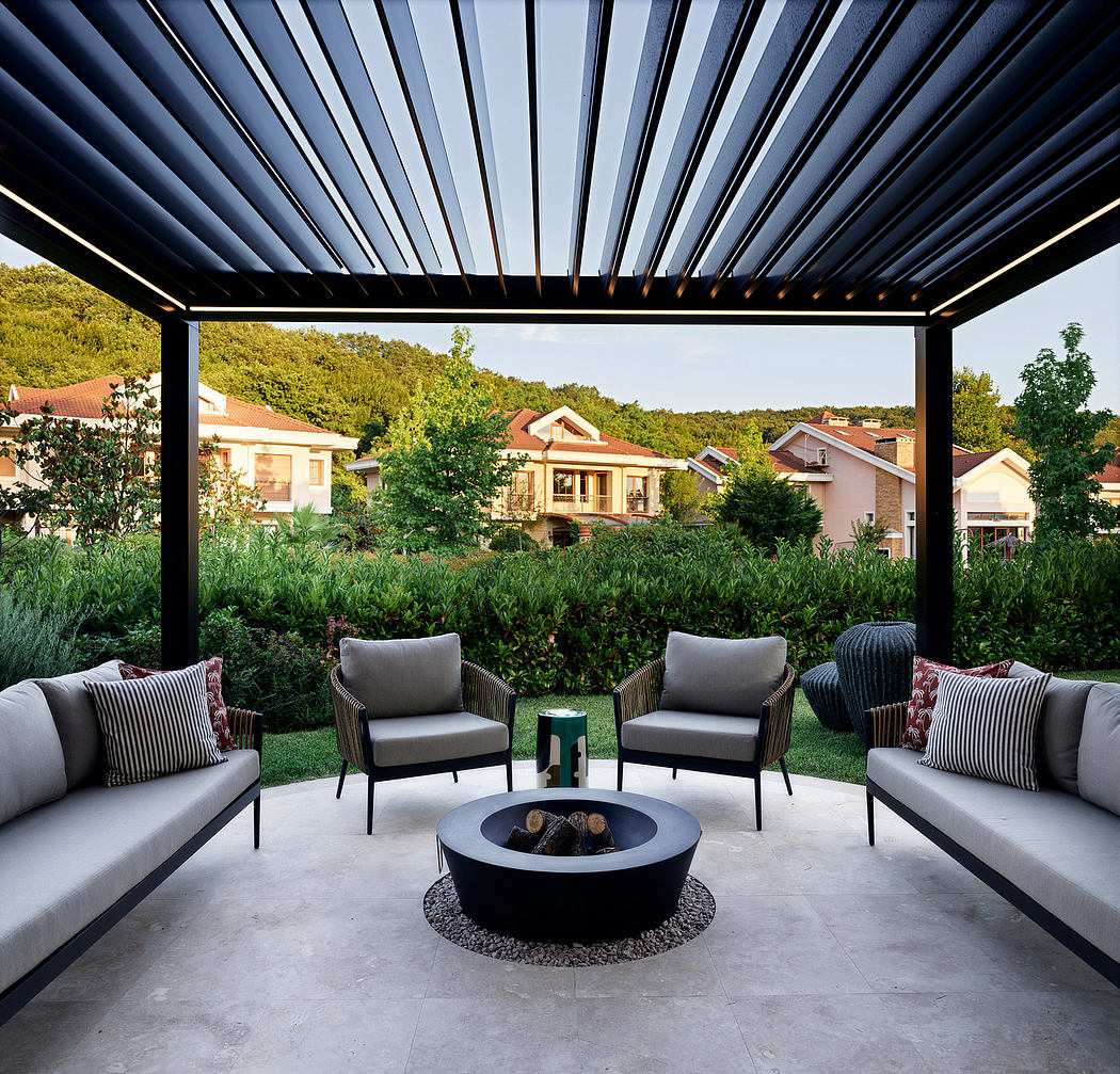 Cozy outdoor living area with pergola, comfortable seating, and a stylish fire pit.