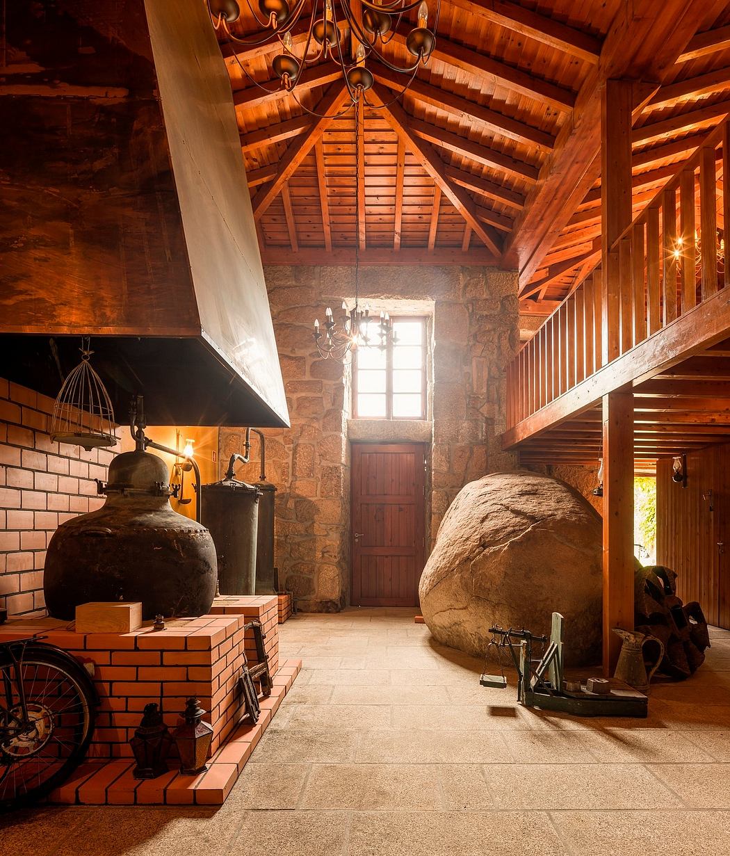 A cozy rustic interior with exposed wooden beams, stone walls, and a large fireplace.