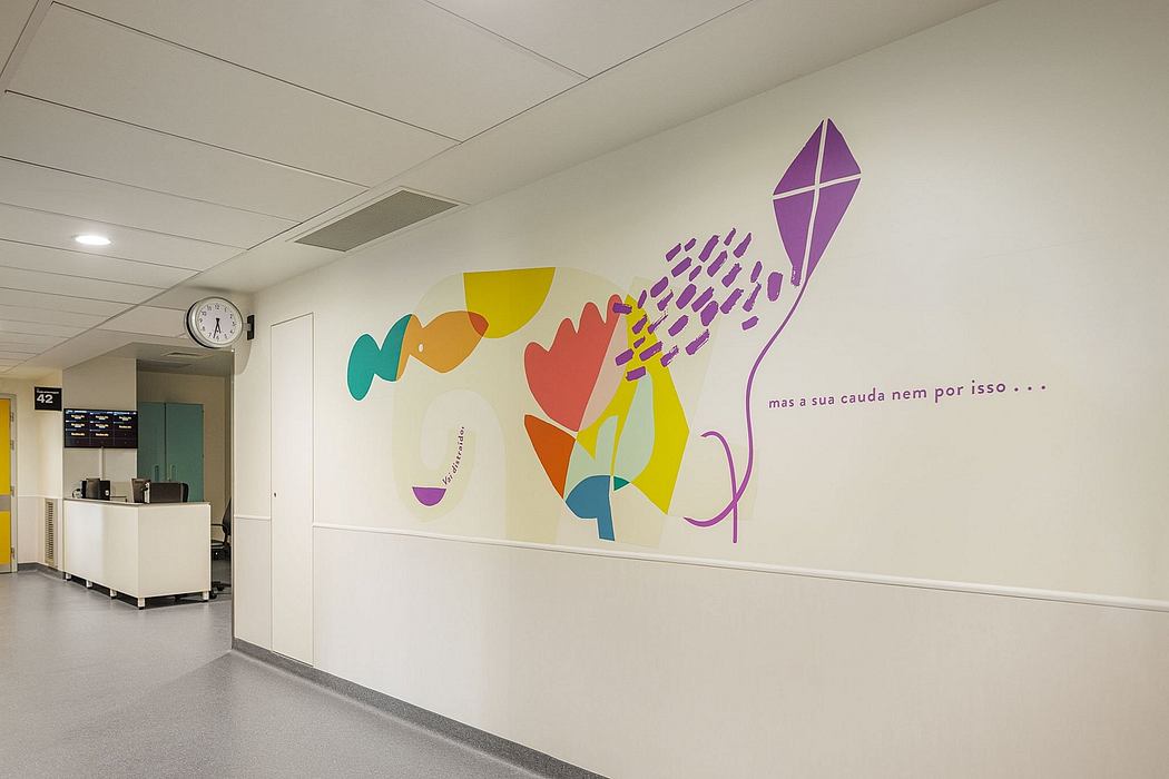 Colorful abstract artwork adorns the white walls of this modern, minimalist space.