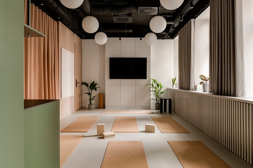 A modern, minimalist studio space with geometric shapes, natural textures, and suspended lighting.