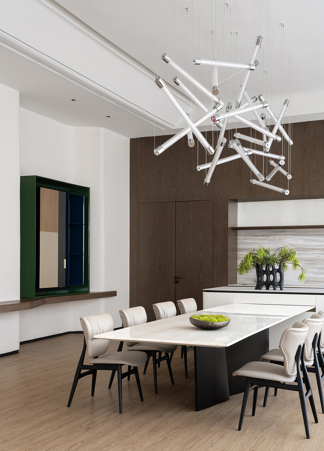 Sleek, modern dining room with geometric lighting fixture and minimalist decor.