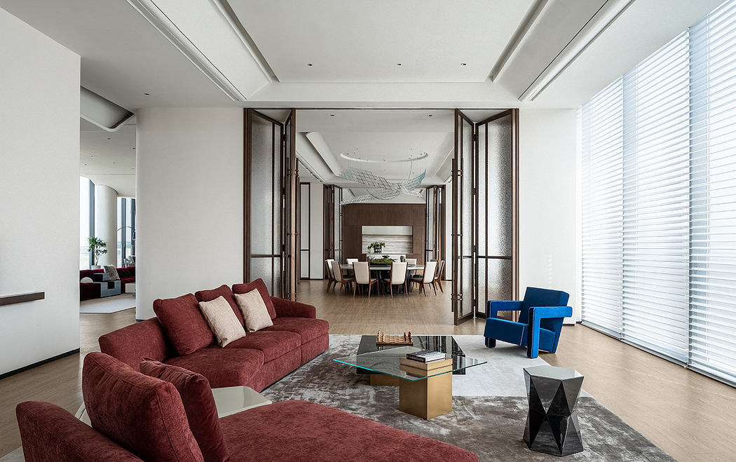 Elegant, modern living space with plush seating, glass coffee table, and sliding doors leading to dining area.