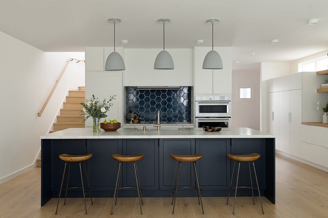 Sleek, modern kitchen with dark cabinetry, hexagonal tile backsplash, and pendant lights.