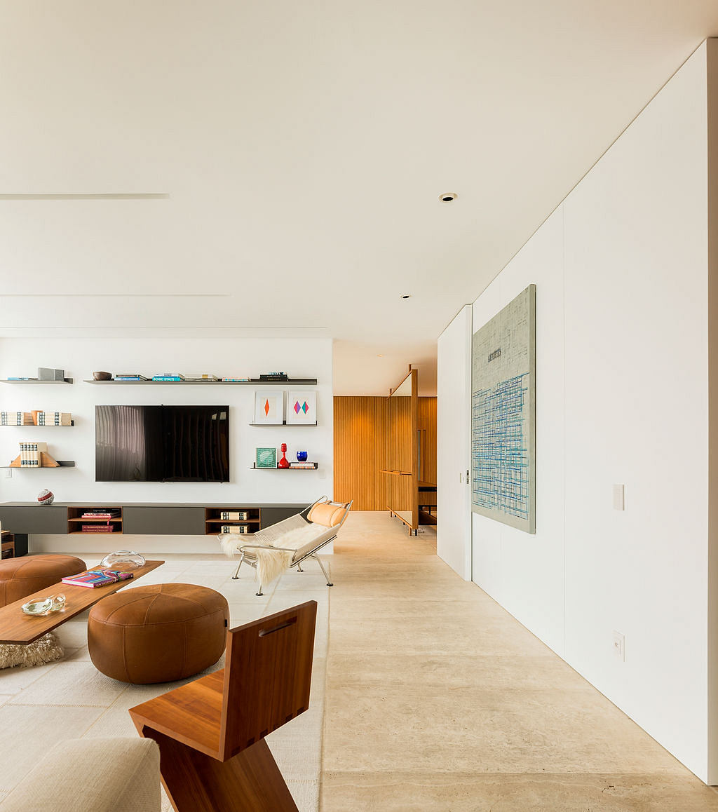 A modern living room with sleek shelving, minimalist furnishings, and a striking abstract wall art.