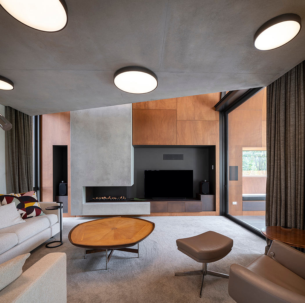Modern living room with concrete walls, wood panels, and minimalist furniture.