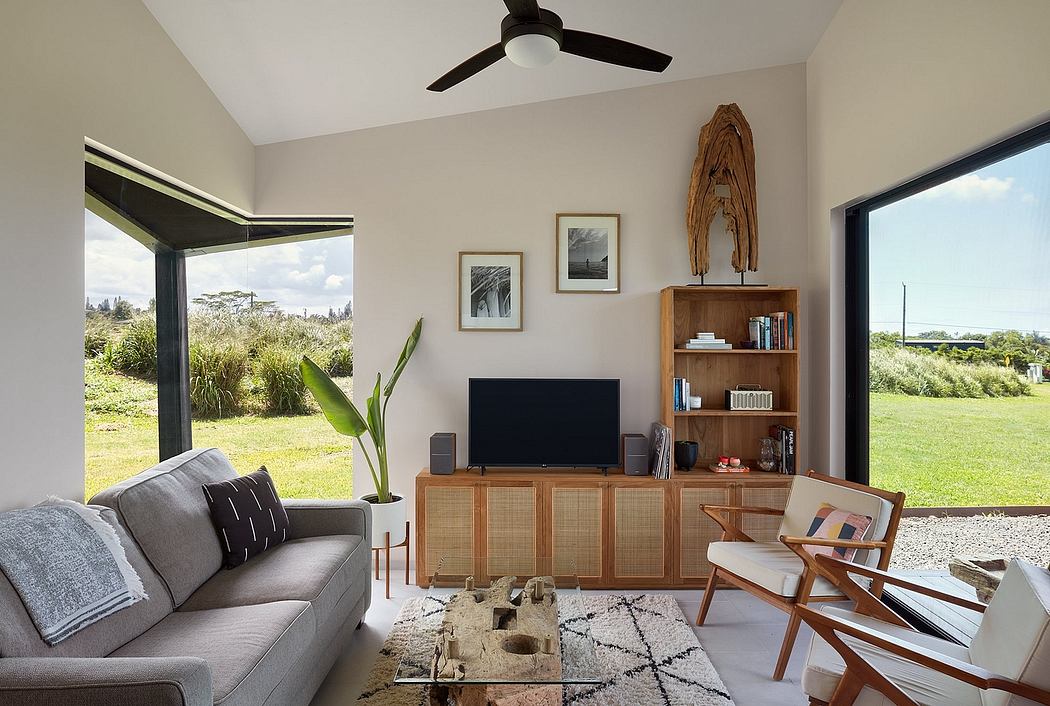 Well-appointed modern living room with sleek furniture, natural elements, and scenic views.