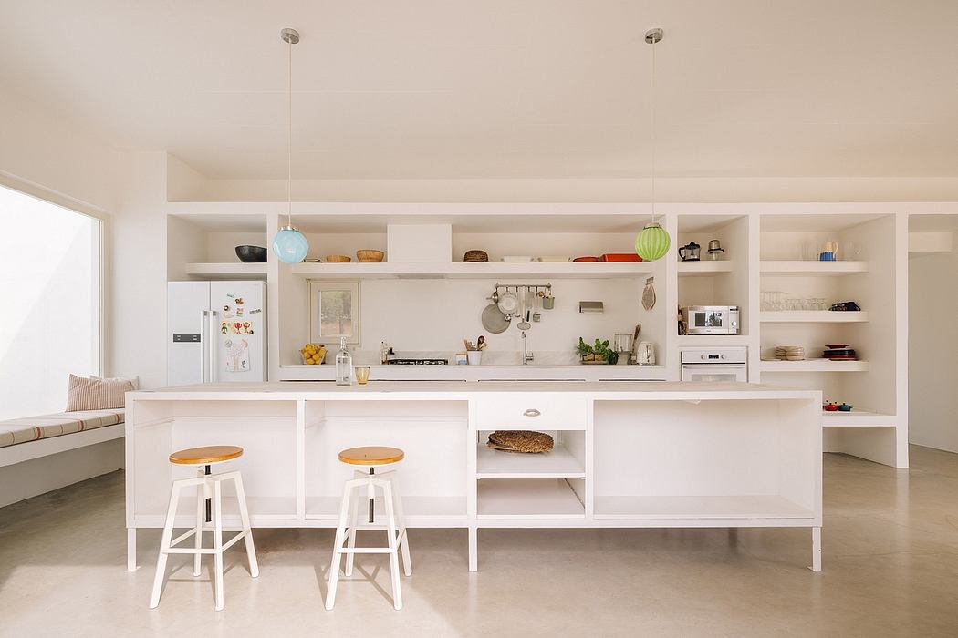 Bright, modern kitchen with open shelving, sleek white cabinetry, and a central island.