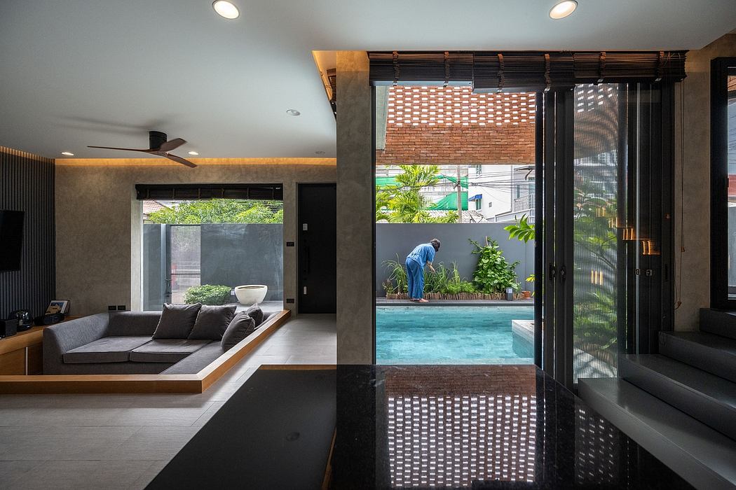 Elegant modern interior with sleek concrete, wood, and glass elements; inviting outdoor pool.
