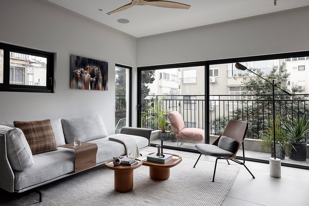 Cozy modern living room with large windows, neutral color palette, and contemporary furniture.