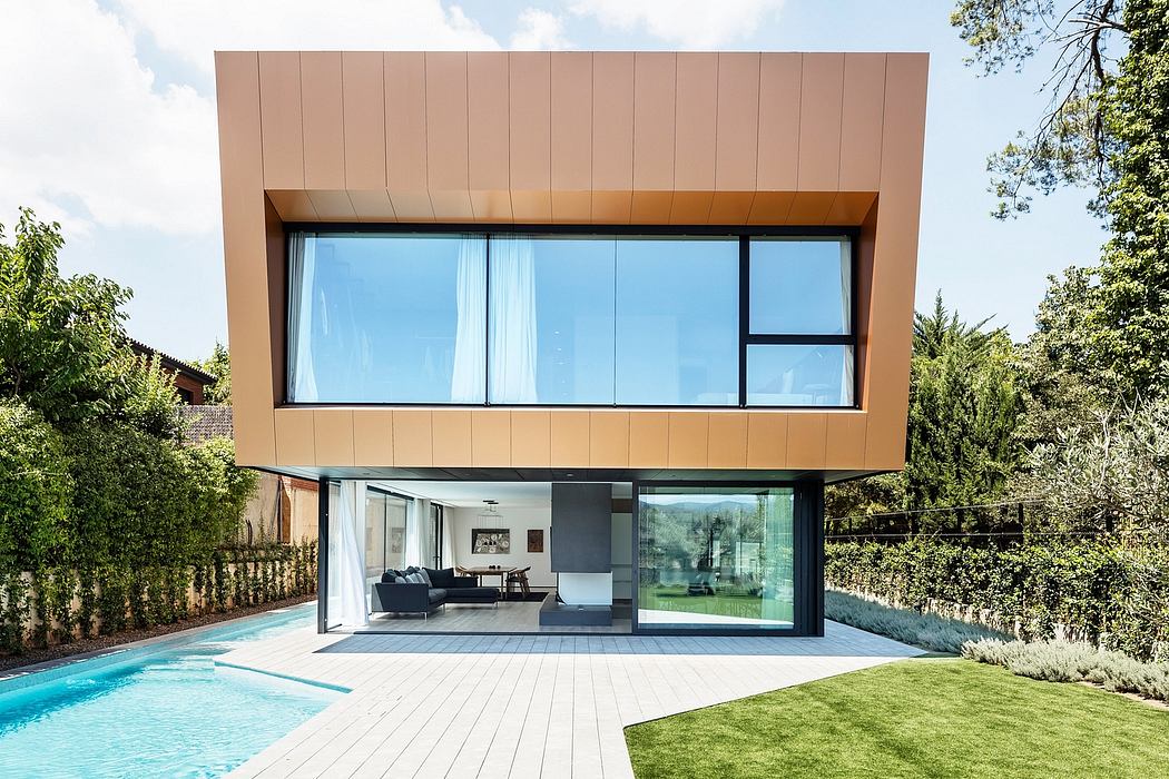 Sleek modern architecture with glass walls, wooden siding, and a private pool.
