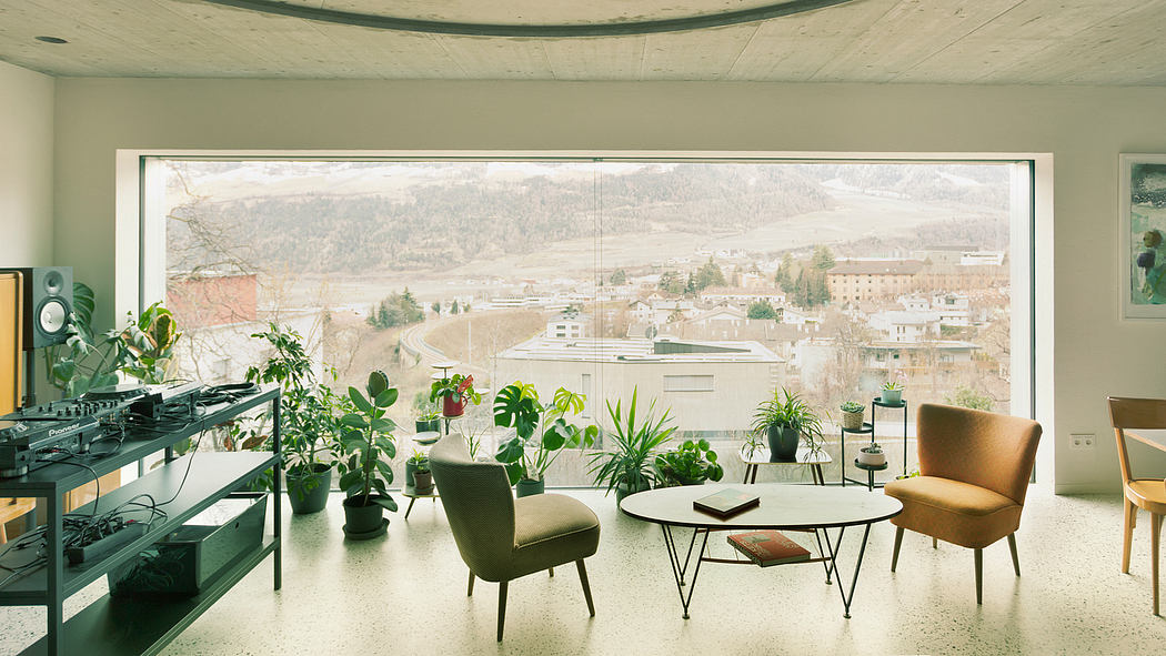 Cozy modern room with panoramic mountain view, indoor plants, and stylish furniture.