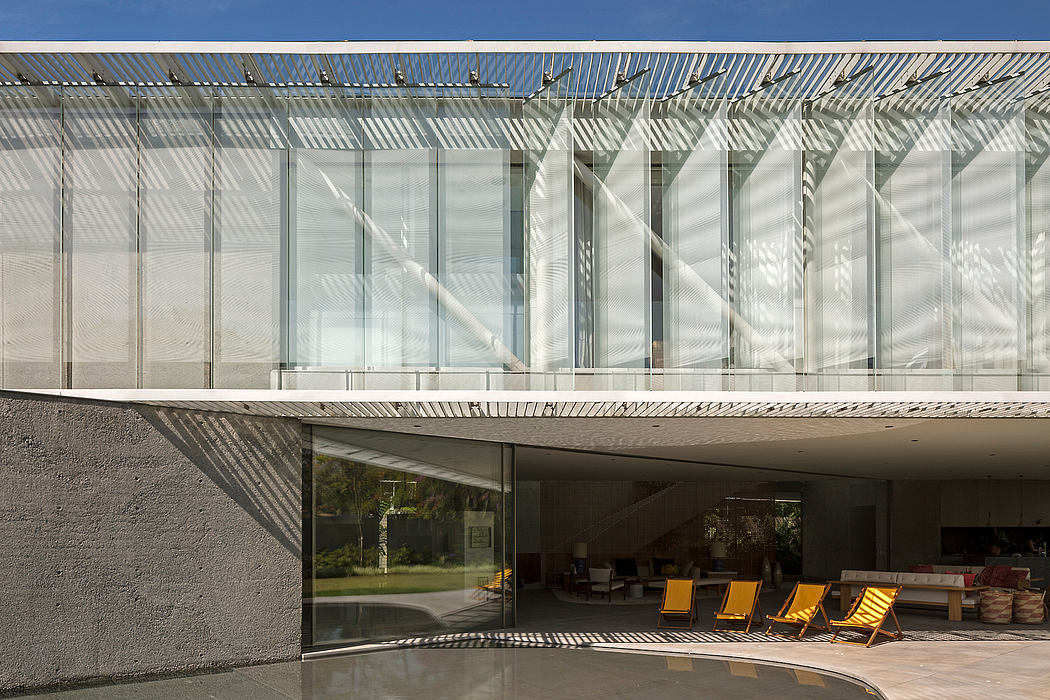 Modern architectural façade with glass panels and geometric patterns casting dynamic shadows.