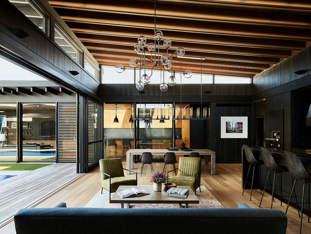 Sleek modern interior with wood-beamed ceiling, chandelier, and plush seating arrangement.