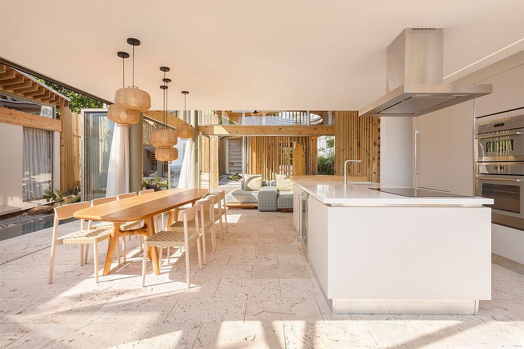 Spacious open-plan kitchen and dining area with modern decor and natural materials.