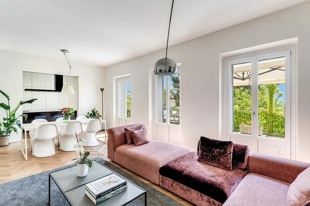 Spacious, light-filled living area with modern furniture, floor-to-ceiling windows, and sleek design.