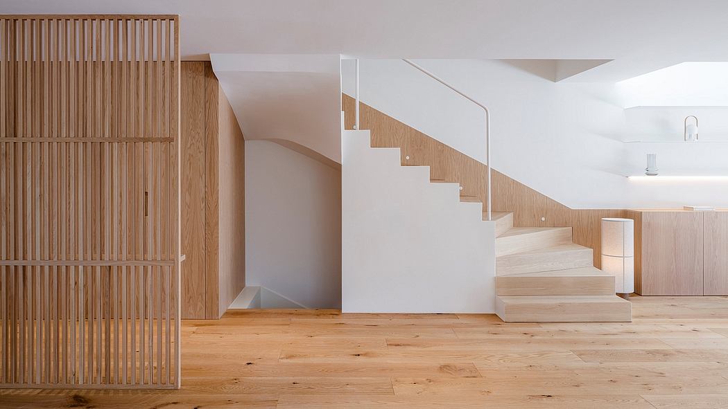 A modern, minimalistic interior with wooden slatted walls and a floating staircase.