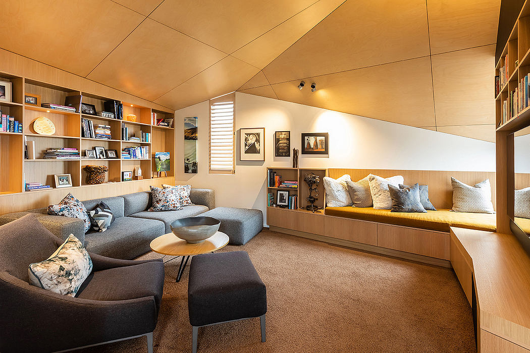 Cozy, modern living room with built-in shelving, seating, and warm lighting.