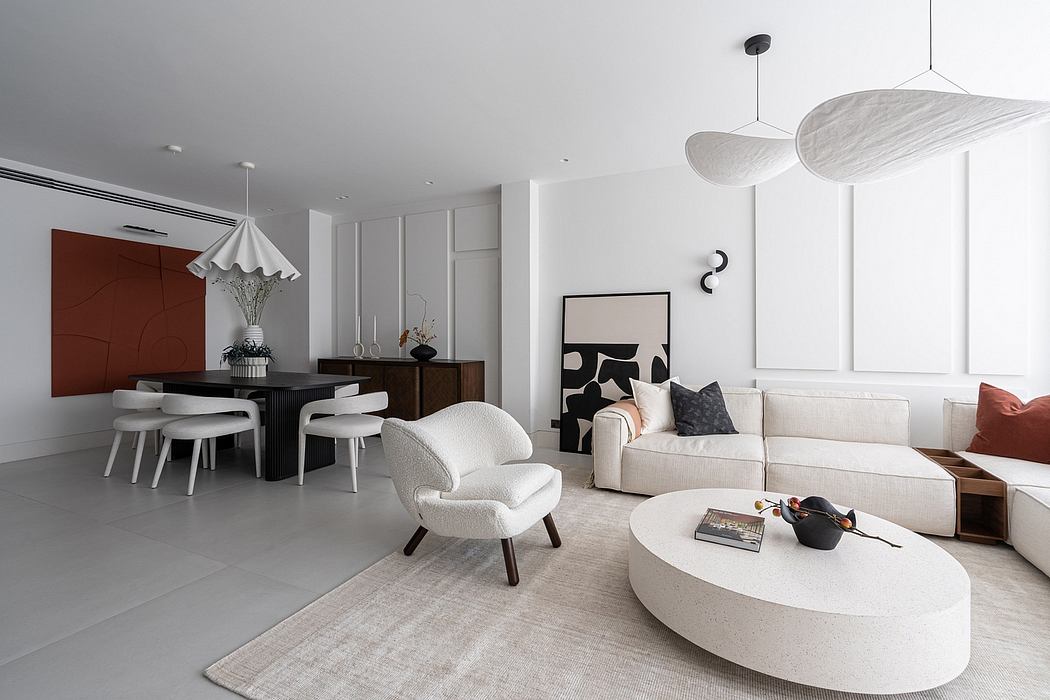 Sleek, modern living space with neutral color palette, minimalist furnishings, and striking lighting fixtures.