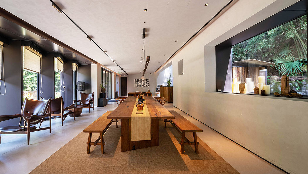 Spacious modern dining room with rustic wood table and benches, large windows.