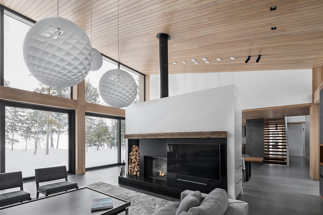 Spacious, modern living room with large windows, spherical pendant lights, and a sleek fireplace.