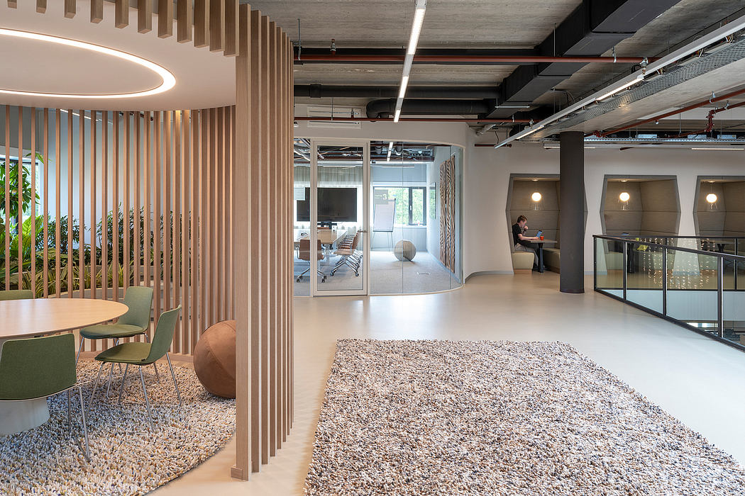 Modern office space with wood accents, comfortable seating, and open floorplan.