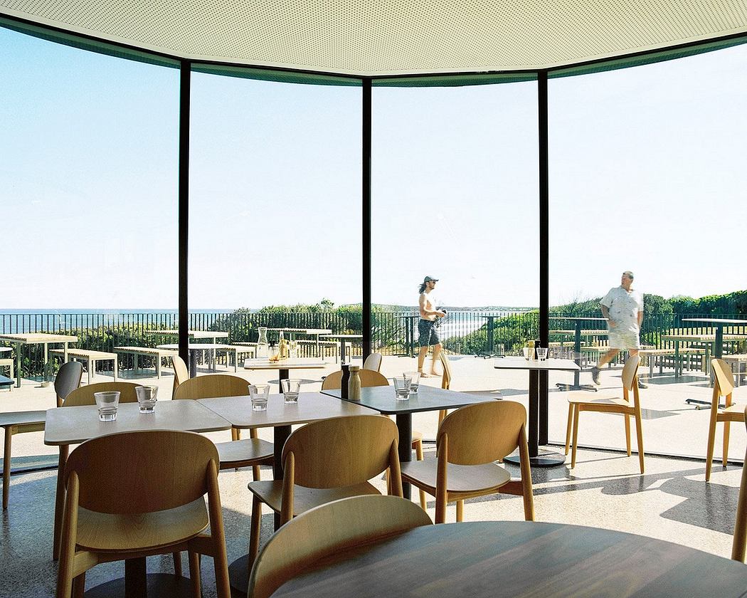 Elegant outdoor dining terrace with modern furniture, glass panels, and sweeping views.