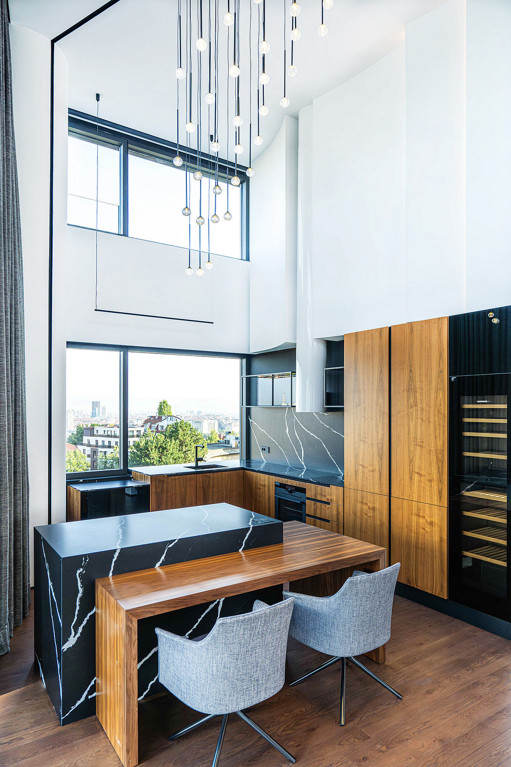 Sleek modern kitchen with floor-to-ceiling windows, contrasting wood and marble finishes.
