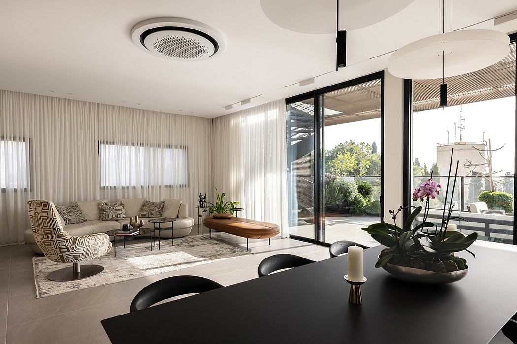 Spacious contemporary living room with large windows, modern furniture, and decorative accents.