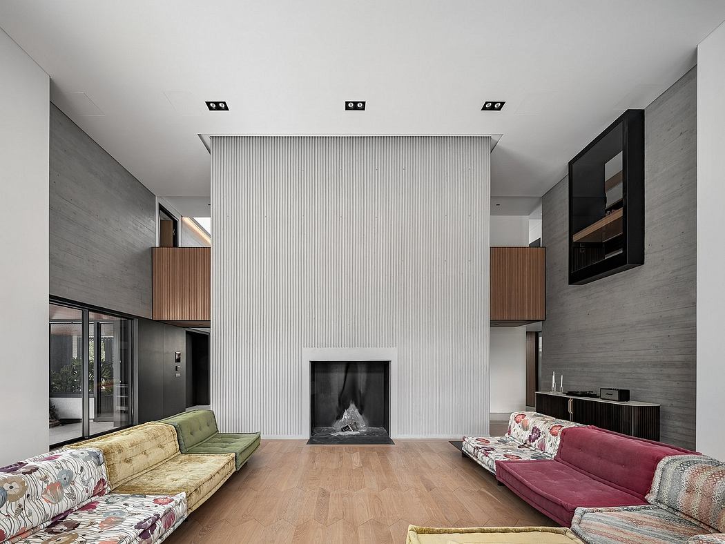 A modern living room with a large fireplace, built-in storage, and distinct material textures.