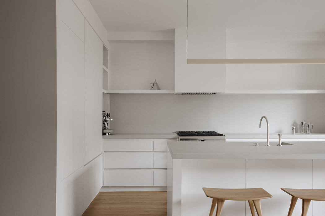 Minimal kitchen with clean lines, integrated appliances, and wooden accents.