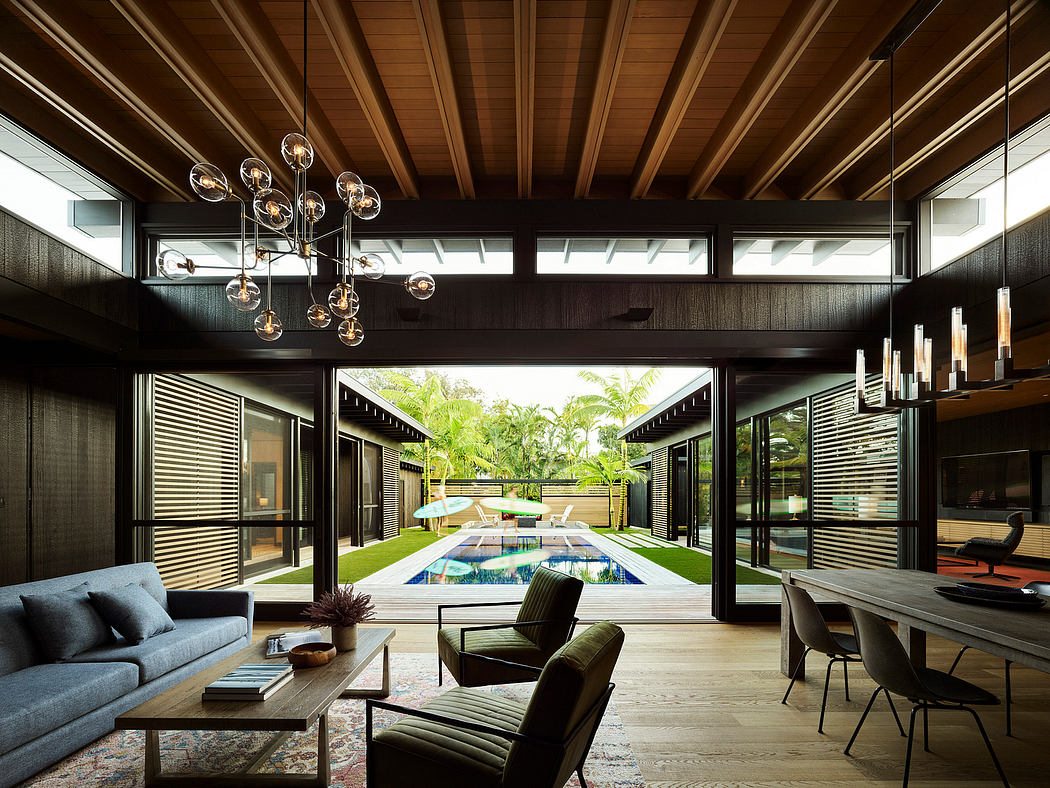 Expansive glass walls, sleek wood beams, and a stylish indoor-outdoor pool design.